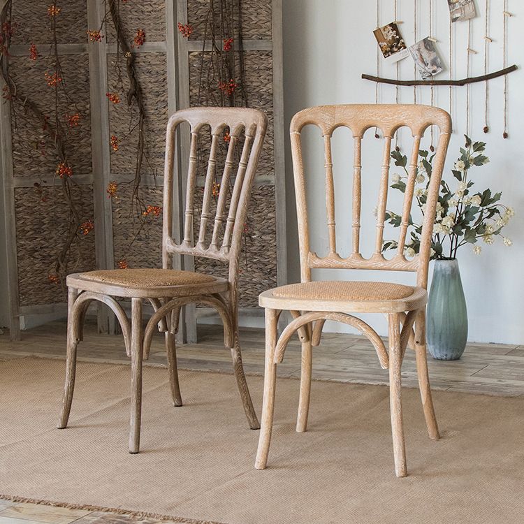 La salle à manger traditionnelle en bois massif préside les chaises à dossier à lamelles de finition mate