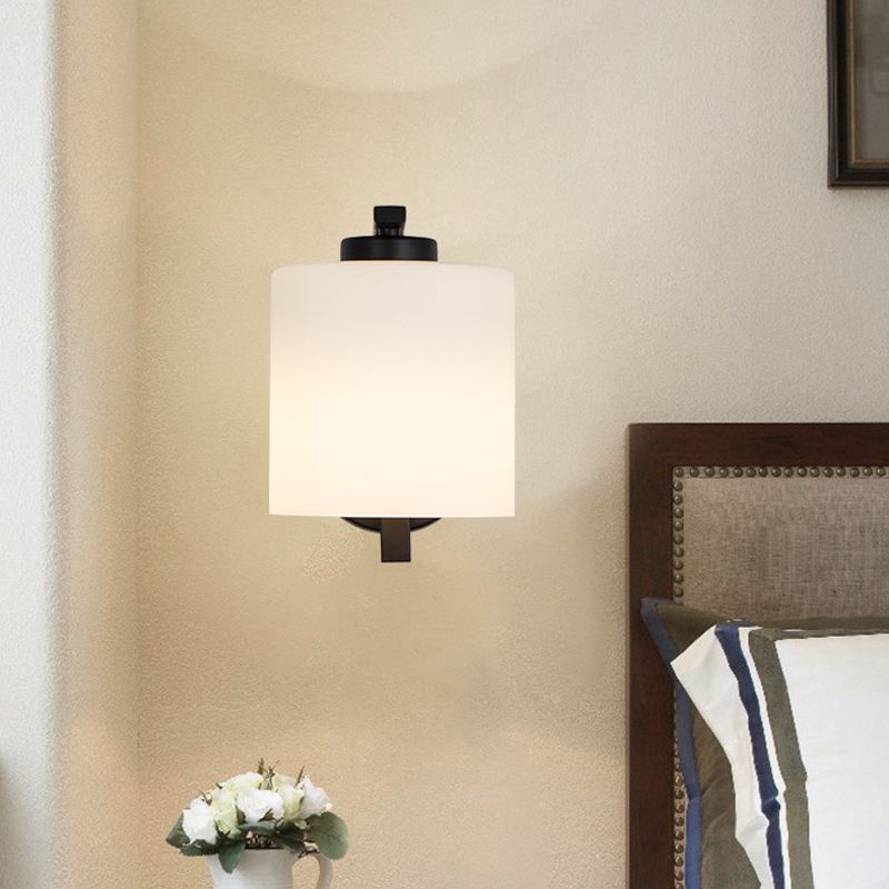 Black 1-Light Wall Sconce Simple Ivory Glass Cylinder Wall Mounted Lamp with Curved Arm