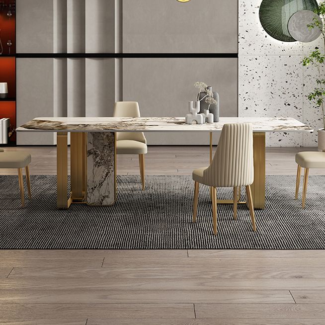Mesa de comedor de piedra sinterizada de lujo con metal y piedra doble pedestal en oro