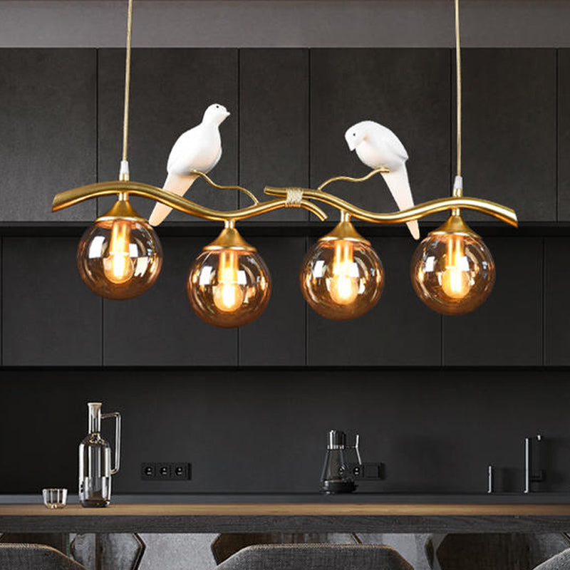 Sprig Island Pendant Light Postmodern Iron 4-Light Black/Gold Hanging Lamp with Amber Ball Glass Shade and Bird Deco