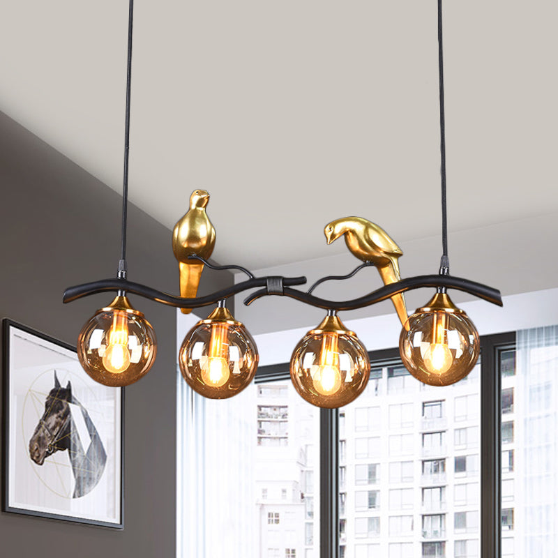 Sprig Island Pendant Light Postmodern Iron 4-Light Black/Gold Hanging Lamp with Amber Ball Glass Shade and Bird Deco