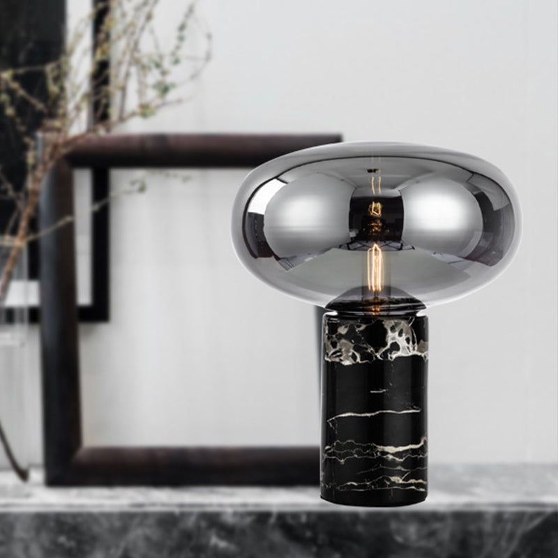 Lampada da tavolo da soggiorno ovale postmoderna in vetro grigio/ambra con 1 lampadina con base cilindrica in marmo nero