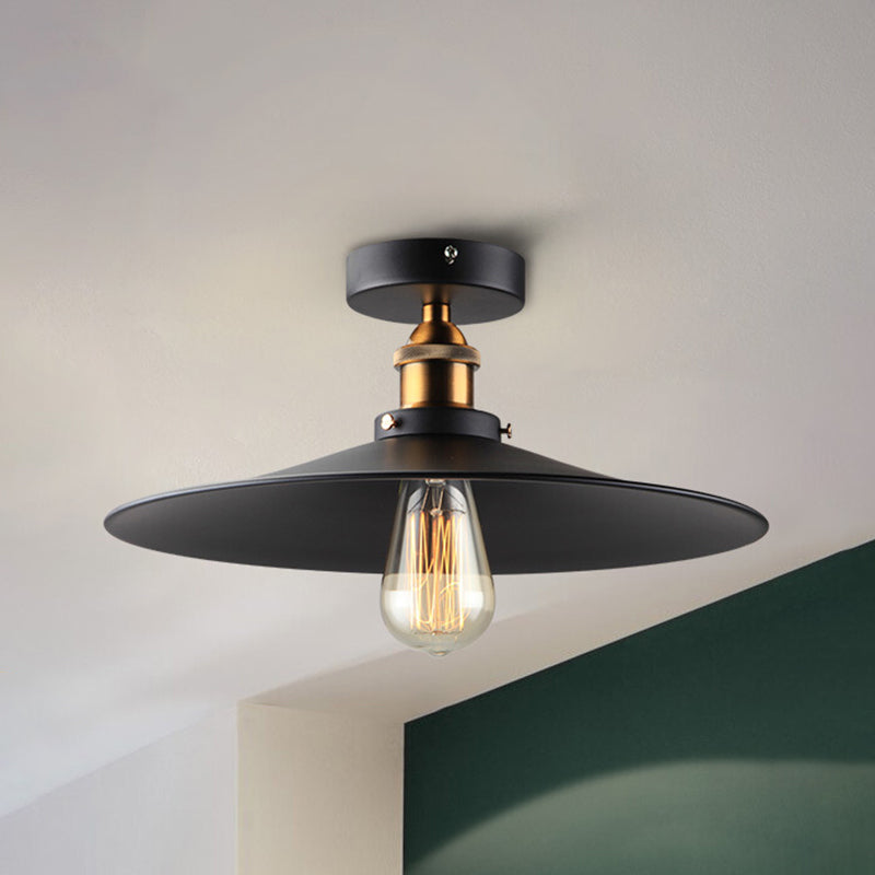 Ristorante industriale in metallo con lampada da soffitto a cono nero vicino all'illuminazione a soffitto