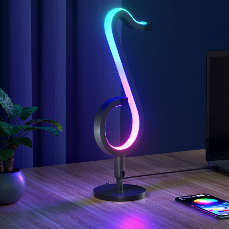 Lampada da tavolo a forma di nota musicale in metallo. Luce notturna a LED nera minimalista alla moda per camera da letto