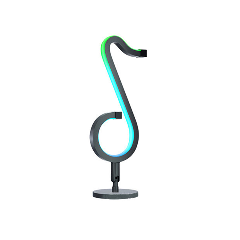 Lampada da tavolo a forma di nota musicale in metallo. Luce notturna a LED nera minimalista alla moda per camera da letto