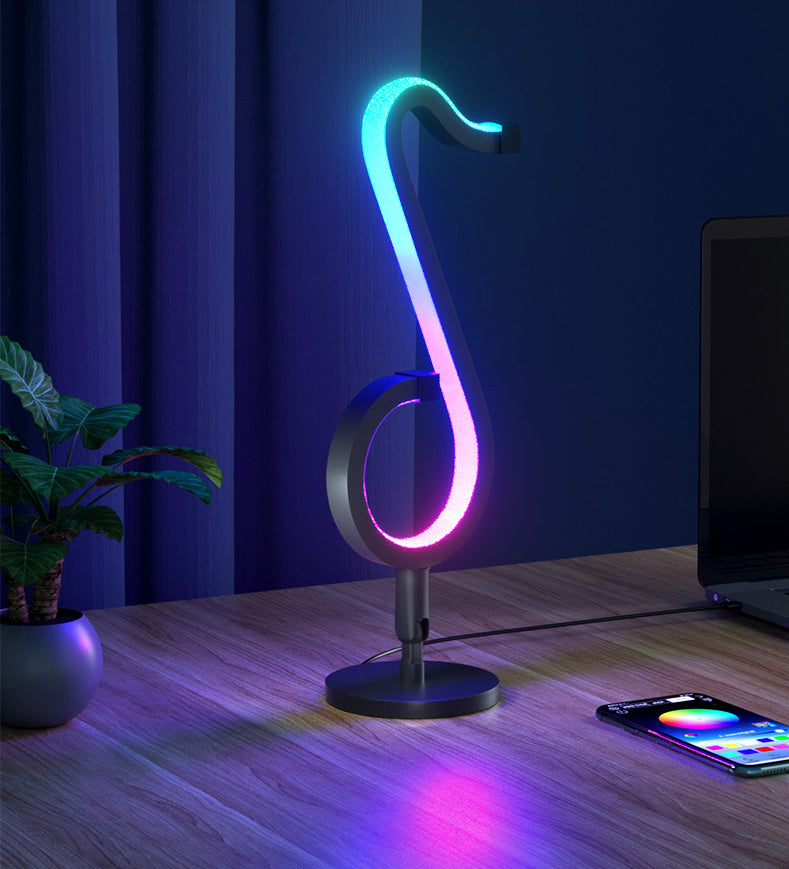 Lampada da tavolo a forma di nota musicale in metallo. Luce notturna a LED nera minimalista alla moda per camera da letto