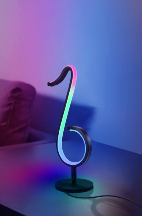 Lampada da tavolo a forma di nota musicale in metallo. Luce notturna a LED nera minimalista alla moda per camera da letto