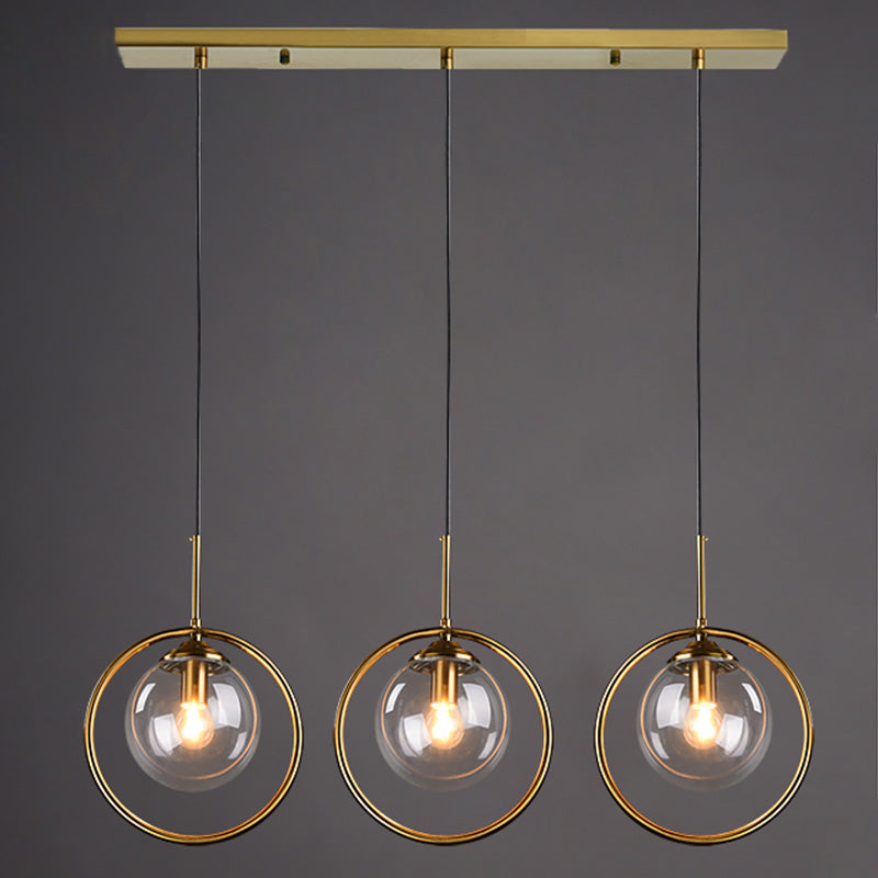 Salle à manger trois têtes forme de sphère suspendue en verre clair et métal moderne