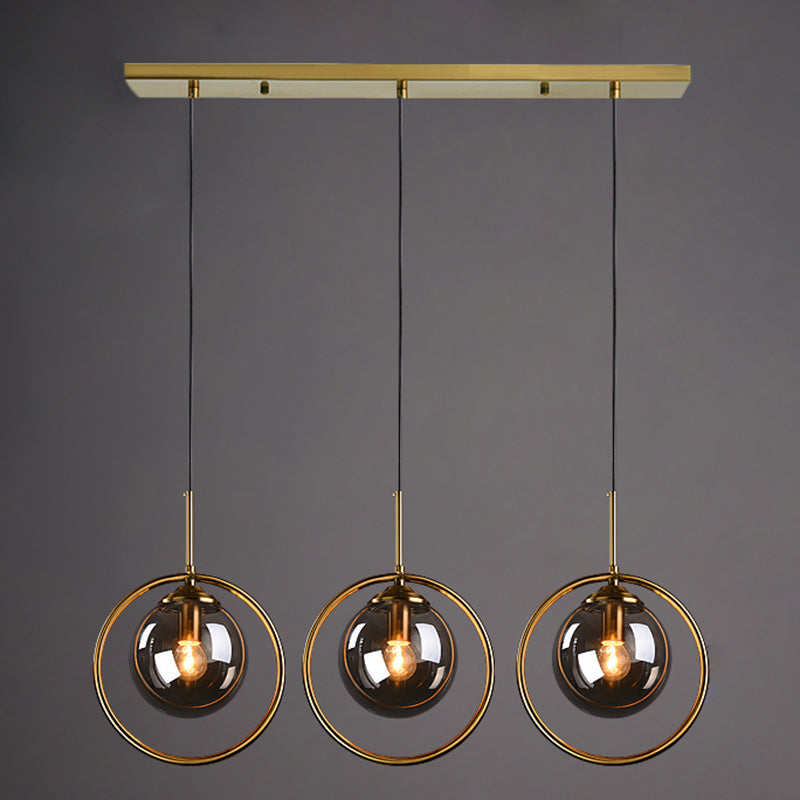 Salle à manger trois têtes forme de sphère suspendue en verre clair et métal moderne