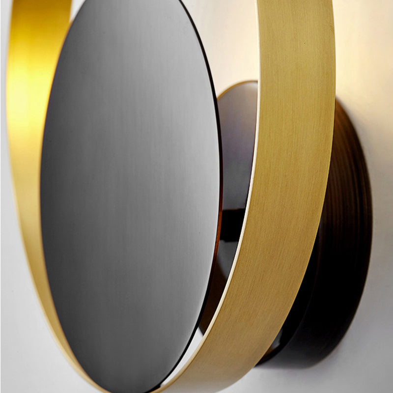 Lampada a parete circolare nera e oro nella moderna semplicità della parete in ferro battuto per gli spazi interni