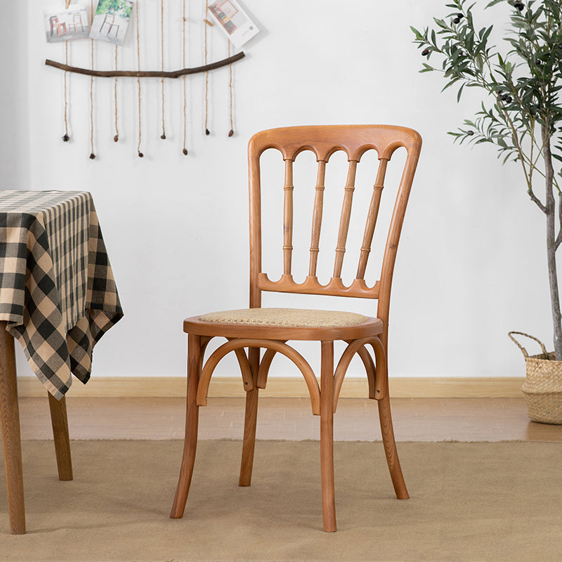 La salle à manger traditionnelle en bois massif préside les chaises à dossier à lamelles de finition mate