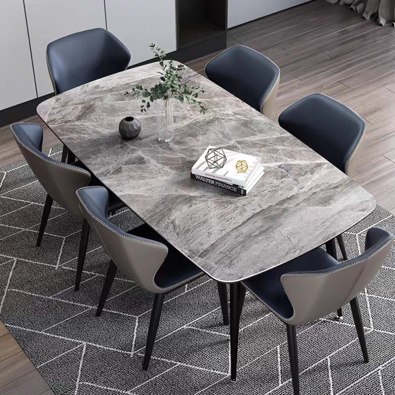 Juntos de comedor modernos con mesa de piedra sinterizada y sillas tapizadas