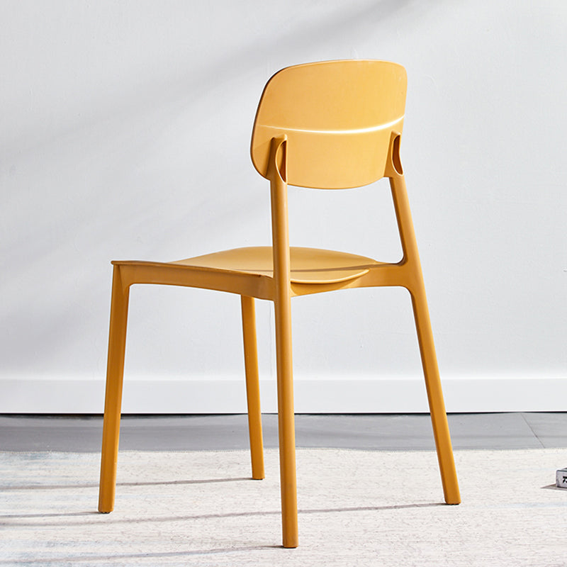 Stapelbarer Beistellstuhl aus Kunststoff im minimalistischen Stil. Bunte armlose Esszimmerstühle für den Heimgebrauch