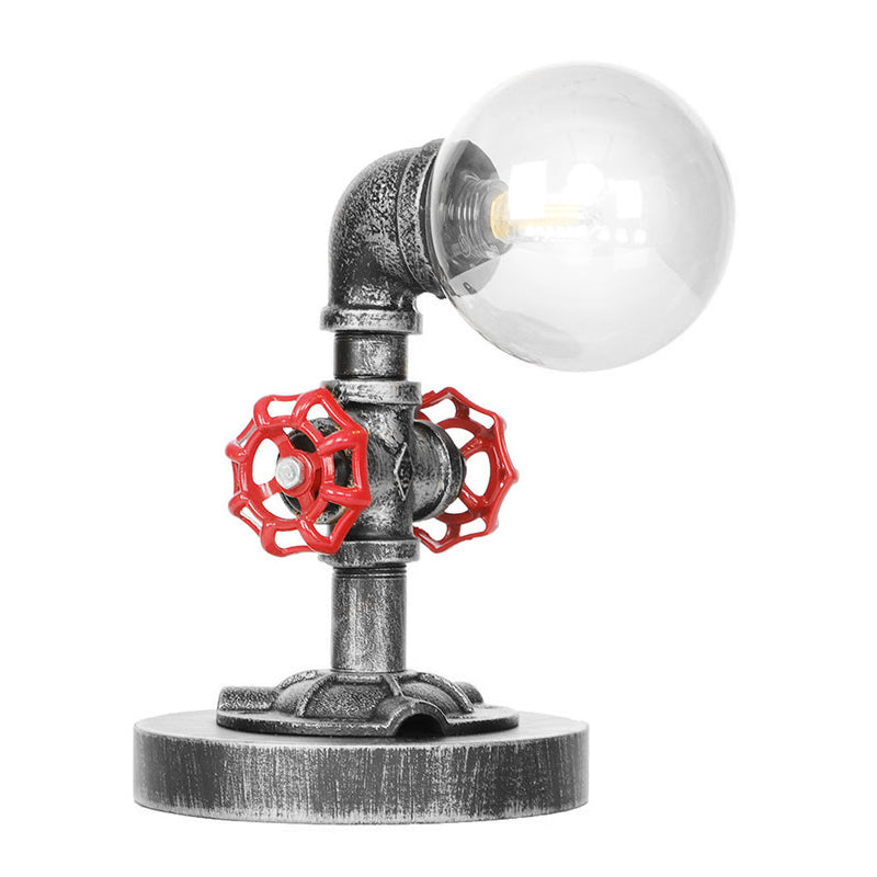 Lampada da lettura a luce singola in argento antico/bronzo. Illuminazione industriale con paralume globo in vetro trasparente/ambrato
