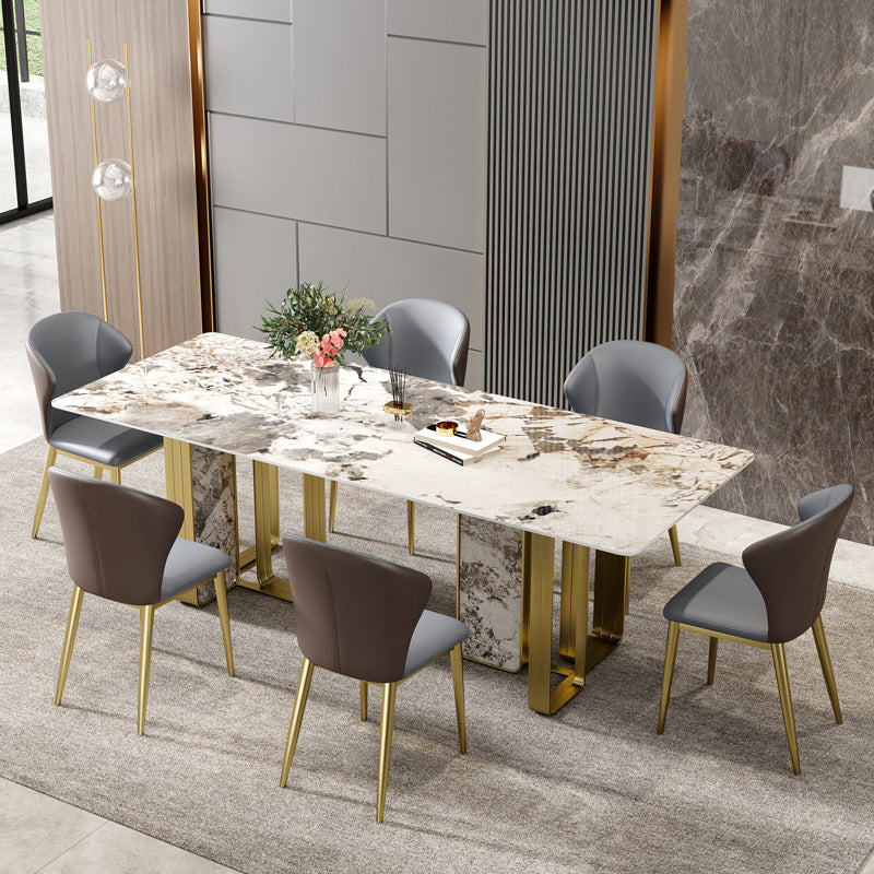 Mesa de comedor rectangular de piedra sinterizada de lujo con pedestal doble dorado