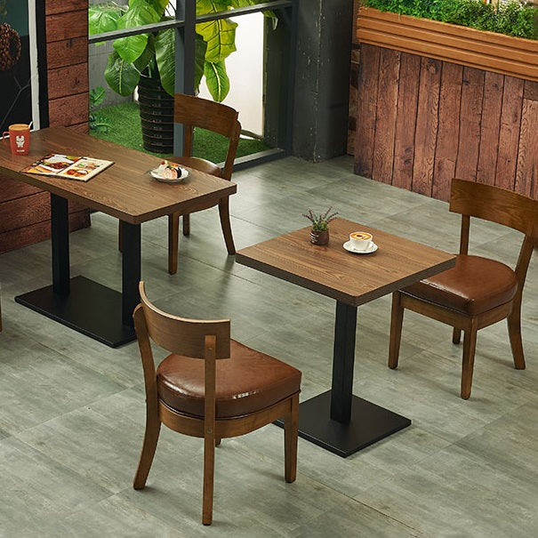 Mesa de comedor industrial de madera maciza con base de pedestal de metal