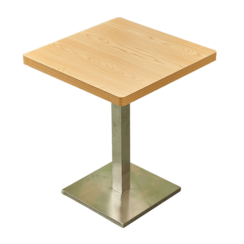 Mesa de comedor industrial de madera maciza con base de pedestal de metal