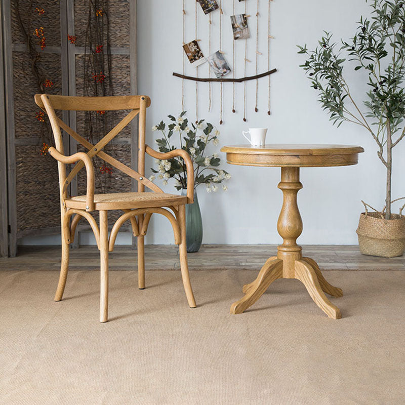 El comedor de madera del cortijo preside los sillones de comedor de mimbre para el uso del restaurante