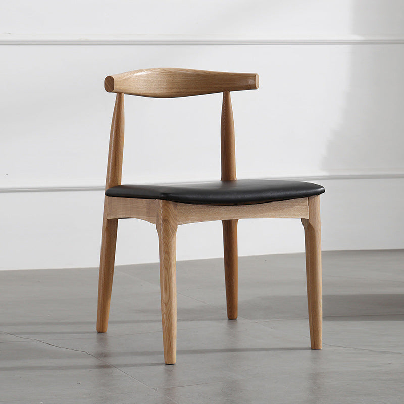 Silla lateral escandinava con respaldo abierto Silla de comedor tapizada con acabado mate