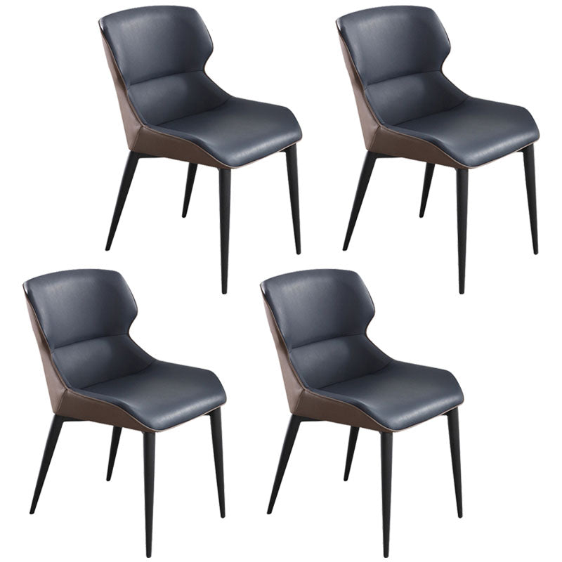 El comedor contemporáneo preside la butaca curvada de cuero mate de Parsons