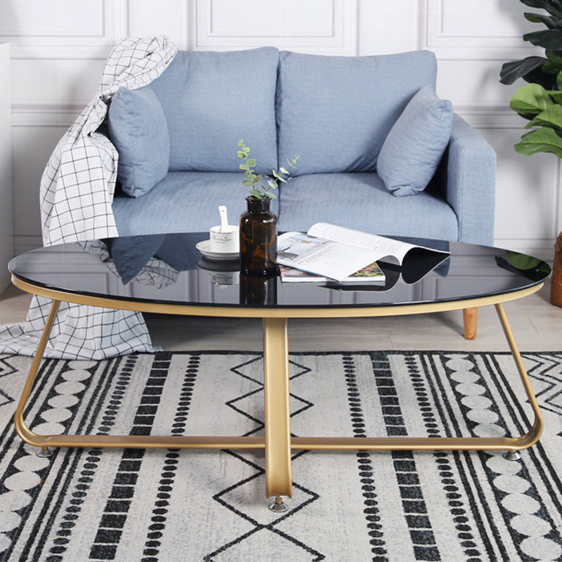 Glam Style Cocktail Table with Oval Top and Golden Iron Cross Base