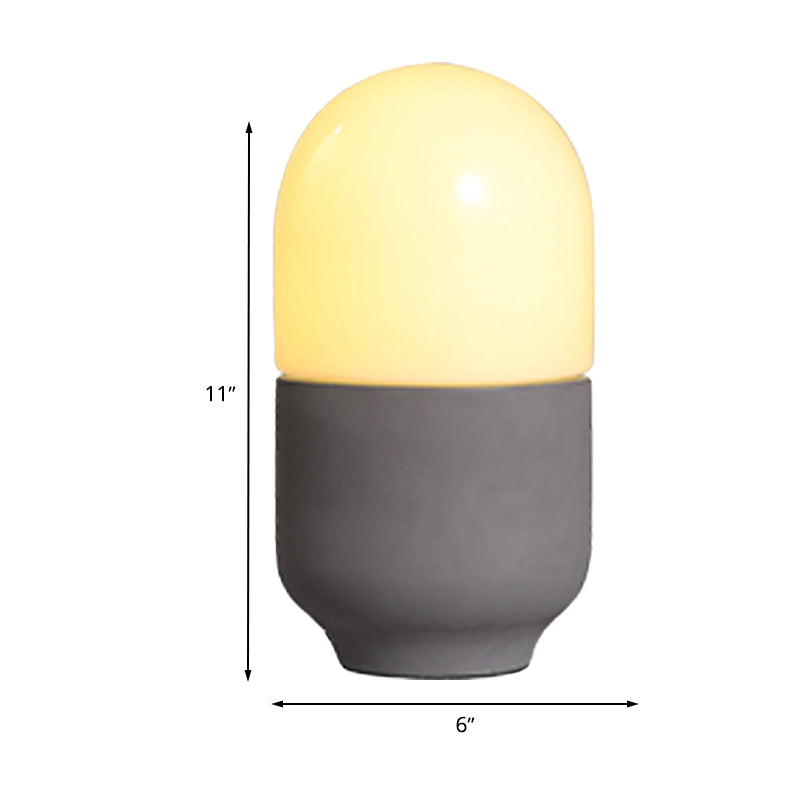 Zementkapselform kleiner Schreibtisch leichte minimalistische LED -Nachttischlampe in Grau mit weißem Glasschatten