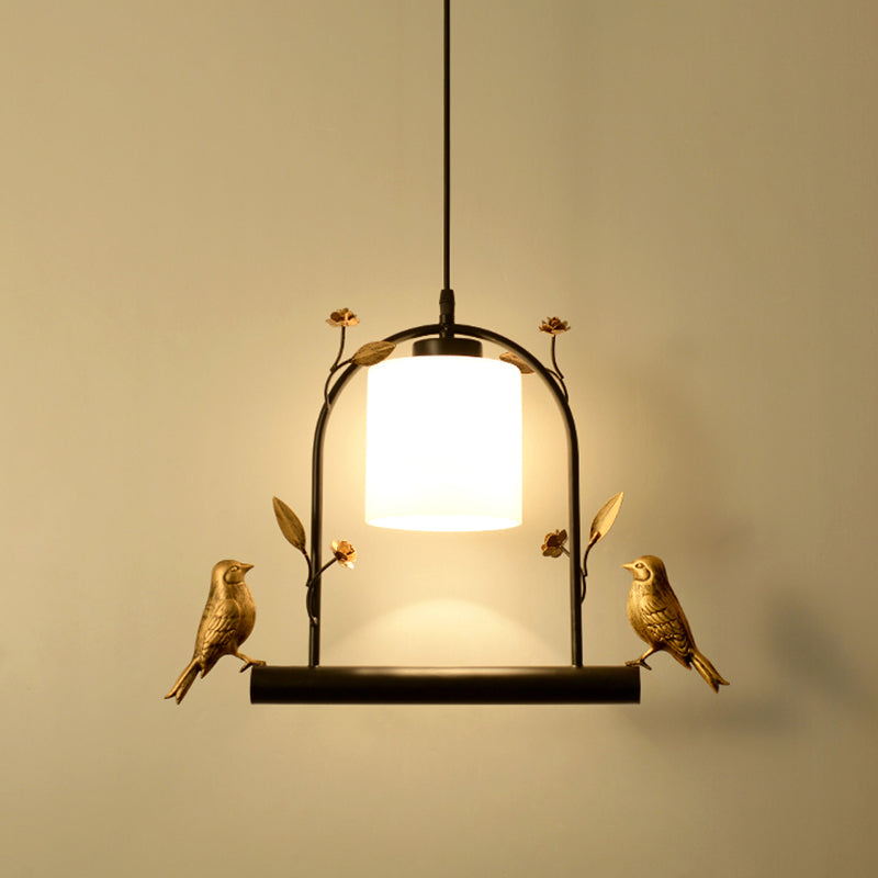 Birdcage Ceiling Light Modernist Metal 1-Head Black and Gold Hanging Pendant with Cylinder Cream Glass Shade and Bird Decor