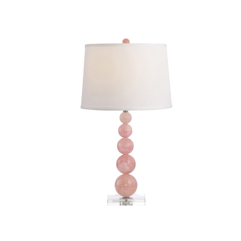 Lampada da comodino con paralume a botte Lampada da comodino bianca singola in tessuto modernista con supporto in vetro rosa con sfere